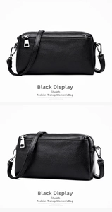 Detail view of black lychee grain genuine leather bag with silver metal zippers