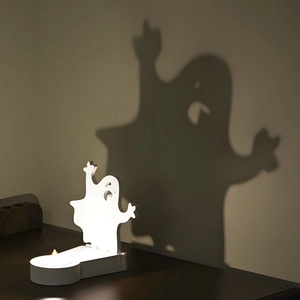 Ghost silhouette candle holder casting a large shadow for Halloween home decor