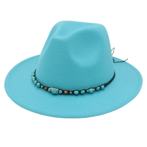 Close-up of bright blue felt cowboy hat with ethnic turquoise beads and braided band