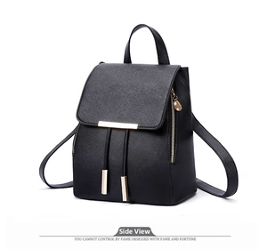 Detail view of black Saffiano PU leather backpack with gold metal trim and drawstrings