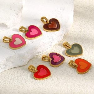 Detail view of heart-shaped 18K gold plated charms with colorful enamel inlays on stone