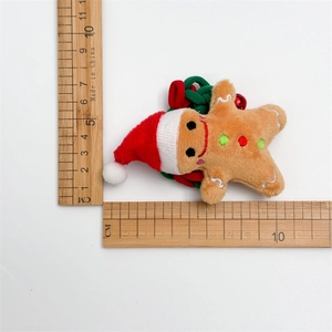 Detail of Christmas gingerbread man plush hair tie with red bell and festive scrunchie