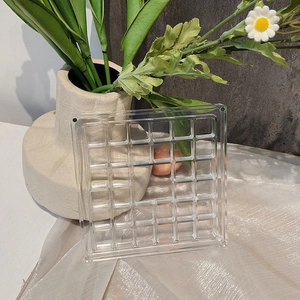 Macro shot of multi-grid acrylic jewelry organizer with magnetic closure for beads