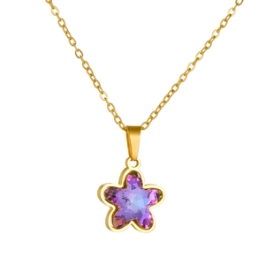Gold star necklace with purple crystal pendant on a minimalist stainless steel chain
