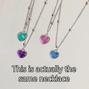 Thermally color-changing heart pendant necklace showing blue and green shifts on silver chain