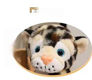 Close-up of leopard plush toy with soft faux fur, blue eyes and detailed texture