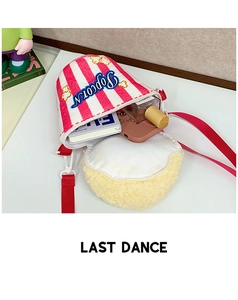 Detail of red and white striped popcorn bucket cross-body bag with plush decoration