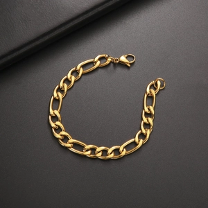 Detailed view of gold Figaro chain bracelet featuring high-quality lobster clasp