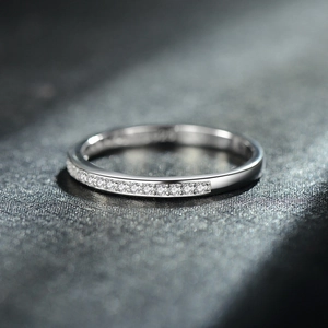 Minimalist S925 sterling silver ring with micro-pave diamond row on dark surface