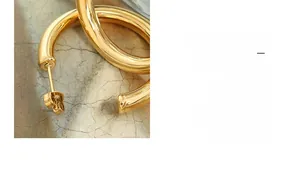 Macro shot of 18K gold plated hollow C-shape hoop earring with high polish finish