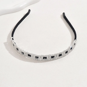 Detail of velvet wrapped headband with sparkling black squares and clear rhinestones
