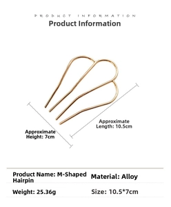 Detailed view of golden M-type 3-prong alloy hairpin with polished high-shine finish