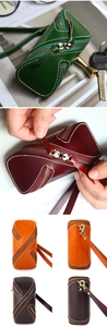 Detail view of multi-color vintage vegetable-tanned leather key cases with secure zipper