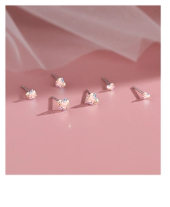 Detailed macro shot of S999 silver heart stud earrings with iridescent pink cubic zirconia