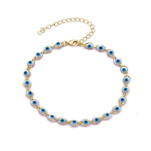 Detail of evil eye charm bracelet with gold finish and adjustable lobster clasp chain