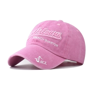 Detail of pink washed cotton baseball cap with white 3D embroidery and jazz patterns