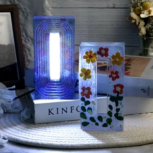 Detail of DIY epoxy resin night light molds showing glitter and floral lamp designs