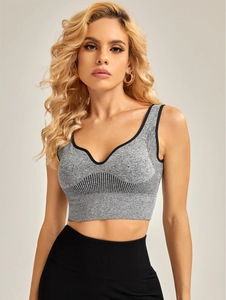 Detail of gray seamless yoga bra with black contrast trim and functional ribbed texture