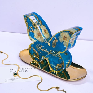 Oversized blue resin butterfly bookend with white dried flowers and Wedding Day text