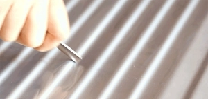 Close-up showing the scratch resistance of silver thickened PVC luggage protector cover