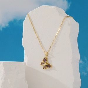 Elegant gold plated necklace featuring a purple butterfly pendant with inlaid gemstone