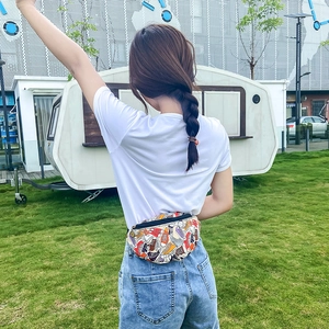 Outdoor wearing shot of minimalist graffiti print canvas waist bag for women