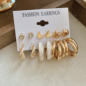 Detail of 12-piece gold earring set with pearls, butterflies and rhinestones
