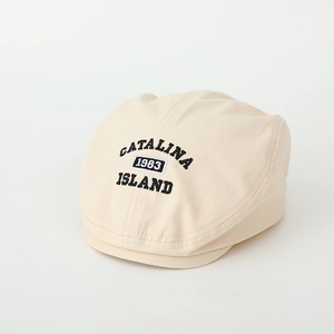 Detailed view of black 1983 embroidery on a beige cotton flat cap with neat stitching