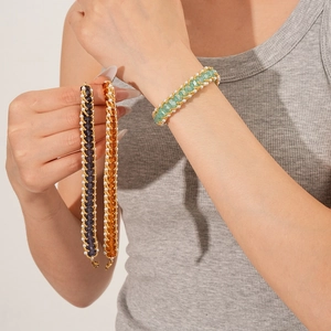 Close-up of handmade woven beaded bracelets with colorful pearls and crystals on wrist