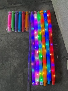 Luminous telescopic tubes stretched to 70cm showing colorful LED lights and accordion texture