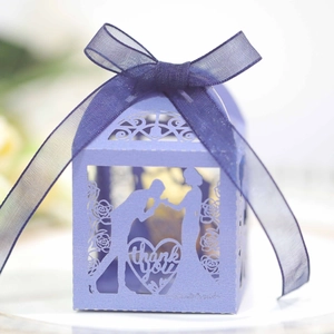 Detailed laser-cut heart pattern on purple candy gift box with elegant silk ribbon
