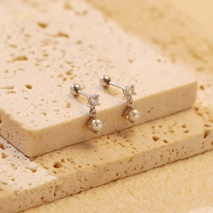 Macro view of elegant S925 silver pearl stud earrings with zircon inlay and screw backs