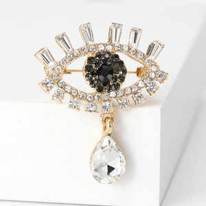 Luxury gold eye brooch with sparkling rhinestones and a crystal teardrop pendant