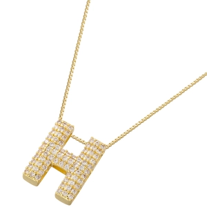 Macro shot of gold-plated H pendant with sparkling pavé zircons on a box chain