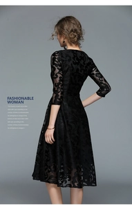 Detail of elegant black lace floral pattern on midi dress with slim waist design