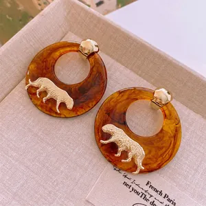 Retro amber resin hoop earrings with gold panther relief and silver needle backing