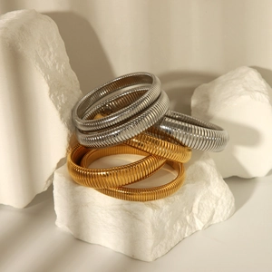 Vintage style 18K gold and silver plated tubogas stretch bracelets on stone pedestals