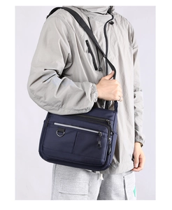 Close-up of navy blue multi-pocket crossbody bag showing durable nylon fabric and adjustable strap