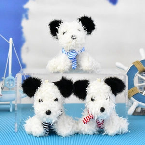 Detail of three cute West Highland Terrier plush keychains with colorful striped scarves.
