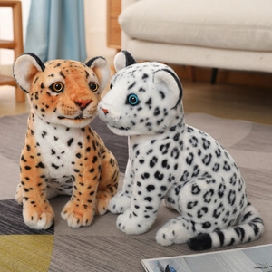 Realistic snow leopard and leopard plush toys with vivid eyes in a cozy home setting