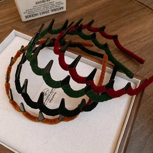Detail of flocked wavy headbands in black, dark green, burgundy and mustard colors