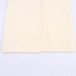 Front view of cream-colored long blazer featuring smooth woven fabric and clean bottom hem