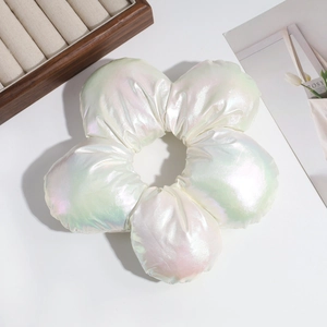 Macro shot of large 3D white satin flower hair scrunchie with iridescent pearl finish