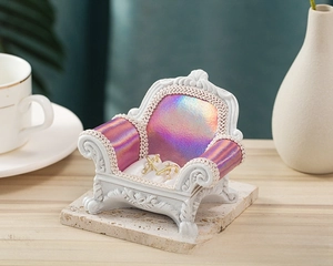 Miniature white sofa jewelry stand with pink fabric and pearls for earring display