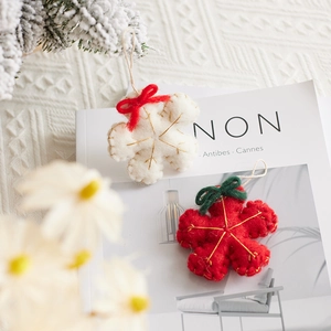 Handmade 8cm wool felt snowflake ornaments with red and white festive bow details
