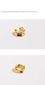 Macro detail of irregular gold wavy earring with a polished metallic finish in natural light