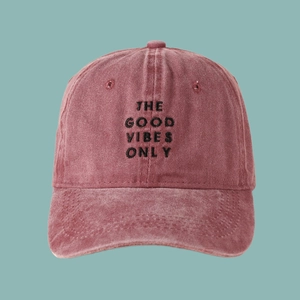 Détail de la casquette de baseball rouge vintage en coton délavé avec broderie texte