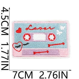 Detailed embroidery of a vintage tape patch with Lover text and decorative heart motifs