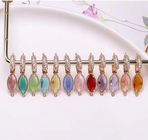 Close-up of multicolored marquise crystal charms with gold-plated ring connectors