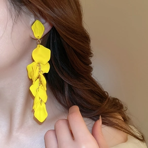 Close-up of yellow flower petal tassel earrings on model showing elegant drape style